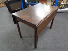 A 19th century mahogany flap sided table fitted a drawer