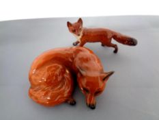 Two Beswick figures, fox curled No. 2017 and fox standing No.