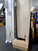 A cast iron boot scraper mounted on a concrete block