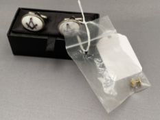 A pair of Masonic cuff links together with a lapel badge