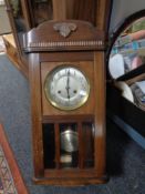 An early 20th century eight day wall clock with silvered dial