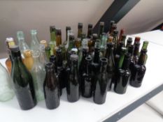 A box and a crate containing a large quantity of antique and later glass and stoneware bottles