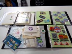 A basket containing five files of scouting memorabilia to include sew on badges,