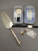 A silver plated cake slice together with three lady's wristwatches,