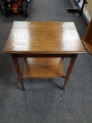 An Edwardian oak two tier occasional table