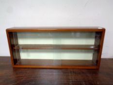 A teak sliding glass door wall shelf