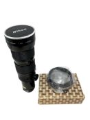 A Nikon lens : Zoom-Nikkor 50~300mm 1:45, numbered 780586.
