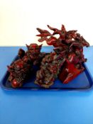 A tray containing five oriental resin figures of foo dogs and men on horseback