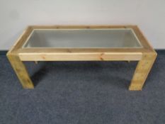 A reclaimed pine glass topped coffee table