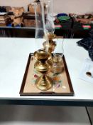 An oak twin handled serving tray together with two brass oil lamps and one further glass oil lamp