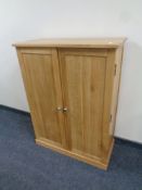 A contemporary oak double door shoe cabinet