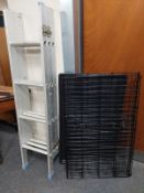 An extending aluminium ladder together with a folding metal pet cage