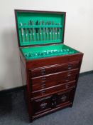 A silver plated cutlery service contained in an oriental style carved hardwood canteen