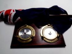 A blue Ensign naval flag on pole together with a Spectrum ship's style clock and barometer mounted