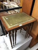 A reproduction mahogany nest of three tables