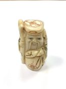 A Chinese bone netsuke - A Bearded Man with Sack.