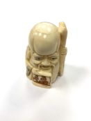A Chinese bone netsuke - Village Elder with Stick.
