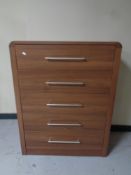 A contemporary wood effect five drawer chest