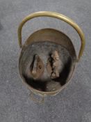 A Victorian brass swing handled coal receiver together with an iron and a cast iron doorstop