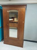 A mahogany mirrored door wardrobe
