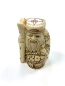 A Chinese bone netsuke - A Village Elder with a Basket of Wares.