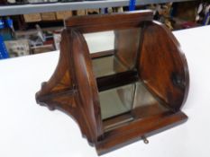 An Edwardian inlaid oak mirrored corner shelf
