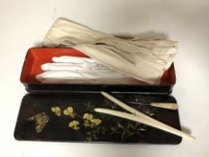 An Edwardian painted glove box containing a pair of lady's calf skin gloves, ivory glove stretchers,