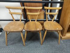 A set of three Ercol elm dining chairs