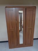 A contemporary wood effect wardrobe with central mirrored door