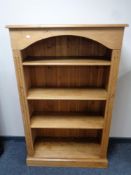 A set of stripped pine open bookshelves,
