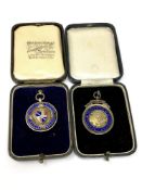Two silver football medals,
