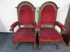 A pair of Edwardian oak high backed armchairs upholstered in a red dralon