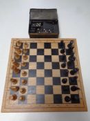 A wooden chess set with pieces together with a box containing dominoes