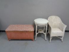 A Lloyd loom glass topped circular occasional table together with a loom basket chair and blanket