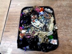A tray containing a quantity of costume jewellery