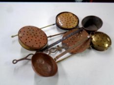 A basket containing four antique chestnut roasters together with an antique copper ladle and an