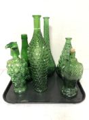 A collection of green coloured glass bottles