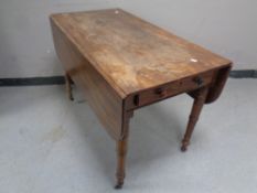 A Victorian mahogany Pembroke table fitted drawers (lacking caster),
