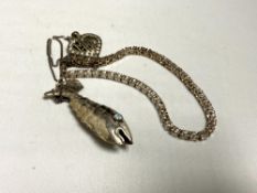A silver tennis bracelet together with a fish pendant and pendant 