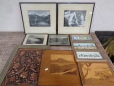 A box containing framed monochrome photographs, alpine scenes, two marquetry panels,