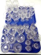 Two trays containing a quantity of cut glass lead crystal drinking glasses to include Stuart