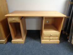 A contemporary pine twin pedestal computer desk (missing keyboard slide),