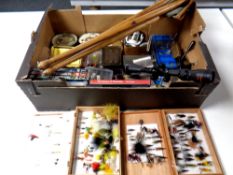 A box of fishing flies in boxes, DVDs relating to fishing, rifle scope, compass, folding stool,