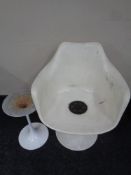 A 20th century moulded plastic armchair on metal base together with a matching metal occasional