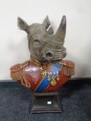 A plastic bust of a rhinoceros in military dress