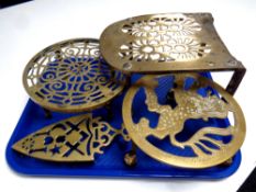 Four antique brass trivets