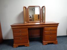 An Olympus Furniture cherry wood knee hole dressing table fitted drawers with triple mirror
