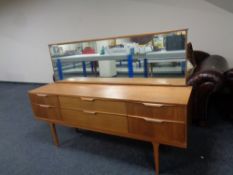 A mid 20th century teak Austin suite six drawer dressing chest on raised legs,