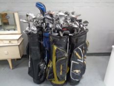 Twelve assorted golf bags containing assorted irons, drivers and putters to include Tailor Made,