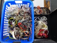A basket and a jewellery box containing a large quantity of assorted jewellery